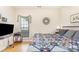 A bright bedroom with hardwood floors, a queen bed, and a bedside table with lamp at 14014 Acorn Creek Ln, Charlotte, NC 28269
