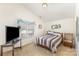 The bedroom provides natural light, carpet floors, tv, and a comfortable chair at 14014 Acorn Creek Ln, Charlotte, NC 28269