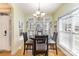 Cozy dining area featuring a chandelier, natural light, and hardwood floors at 14014 Acorn Creek Ln, Charlotte, NC 28269