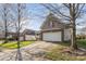 A long driveway leads to a two-car garage on a beautiful home with a well-manicured lawn at 14014 Acorn Creek Ln, Charlotte, NC 28269
