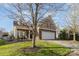 Beautiful home featuring a brick facade, two-car garage, well-manicured lawn, and covered front porch at 14014 Acorn Creek Ln, Charlotte, NC 28269