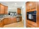Well-appointed kitchen with wood cabinetry, modern appliances, and hardwood floors at 14014 Acorn Creek Ln, Charlotte, NC 28269