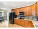 Well-equipped kitchen featuring wooden cabinets, modern appliances and light countertops at 14014 Acorn Creek Ln, Charlotte, NC 28269