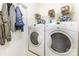 A convenient laundry room area with white washer and dryer units, and storage shelves at 14014 Acorn Creek Ln, Charlotte, NC 28269