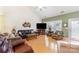 Spacious living room featuring hardwood floors, ample seating, and large windows for natural light at 14014 Acorn Creek Ln, Charlotte, NC 28269