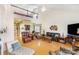 Open-concept living room with a lofted ceiling, hardwood floors, and view of the kitchen and foyer at 14014 Acorn Creek Ln, Charlotte, NC 28269