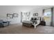 Spacious bedroom boasts a vaulted ceiling, soft carpet, and a comfortable bed complemented by an accent chair at 1420 6Th Ne St, Hickory, NC 28601