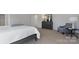 The well-lit room is tastefully furnished with soft carpeting, comfortable bed, and classic grey furniture at 1420 6Th Ne St, Hickory, NC 28601