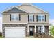 Charming two-story home featuring a stone facade, two-car garage, and well-maintained landscaping at 1420 6Th Ne St, Hickory, NC 28601
