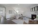 Inviting living room with a fireplace, hardwood floors, and seamlessly connected to the kitchen area at 1420 6Th Ne St, Hickory, NC 28601