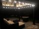 This backyard patio has string lights, outdoor furniture, and a fire pit at 168 Kennerly Center Dr, Mooresville, NC 28115