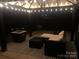 This backyard patio has string lights, outdoor furniture, and a fire pit at 168 Kennerly Center Dr, Mooresville, NC 28115