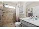 Bathroom featuring a tiled shower and a sink with a large mirror at 168 Kennerly Center Dr, Mooresville, NC 28115