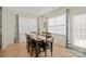 Bright dining room with wood floors, a large table, and a view of the outdoor space at 168 Kennerly Center Dr, Mooresville, NC 28115