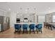 Bright kitchen features a large island with bar seating, stainless steel appliances, and adjacent dining area at 168 Kennerly Center Dr, Mooresville, NC 28115