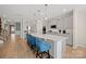 Bright kitchen features a large island with bar seating, stainless steel appliances, and stylish pendant lighting at 168 Kennerly Center Dr, Mooresville, NC 28115