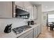 Gourmet kitchen featuring stainless steel appliances, gray cabinets, white subway tile, and quartz countertops at 168 Kennerly Center Dr, Mooresville, NC 28115