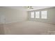 Spacious living room with plush carpeting and a neutral color palette at 168 Kennerly Center Dr, Mooresville, NC 28115