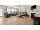 Bright living room featuring hardwood floors, plush seating, a ceiling fan, and large windows at 168 Kennerly Center Dr, Mooresville, NC 28115
