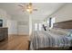 Large main bedroom featuring wood floors and bright, airy feel, with a peek into an exercise area at 168 Kennerly Center Dr, Mooresville, NC 28115
