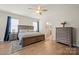 Spacious main bedroom with hardwood floors, a ceiling fan, and an en-suite bathroom at 168 Kennerly Center Dr, Mooresville, NC 28115