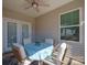 Cozy covered patio furnished with a round table and four chairs, perfect for outdoor dining at 168 Kennerly Center Dr, Mooresville, NC 28115