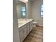 Bathroom features a double vanity, tile floors, and modern fixtures at 1708 Honey Trl, Monroe, NC 28112