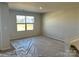 Upstairs bedroom featuring neutral carpet and a window overlooking the street at 1708 Honey Trl, Monroe, NC 28112
