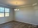 Bright dining room featuring modern lighting, wood floors, and a large window at 1708 Honey Trl, Monroe, NC 28112