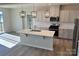 Modern kitchen with island, stainless steel appliances, and elegant pendant lighting at 1708 Honey Trl, Monroe, NC 28112