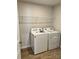 Laundry room featuring a washer, dryer, and wire rack shelving at 1708 Honey Trl, Monroe, NC 28112