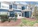 A townhouse backyard featuring well-maintained landscaping, lawn and a cozy patio area at 17537 Tuscany Ln, Cornelius, NC 28031