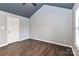 Bright bedroom featuring modern gray color palette, high ceilings and wood-look floors at 17537 Tuscany Ln, Cornelius, NC 28031