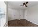 A bedroom featuring wood floors, ceiling fan and a closet with double doors at 17537 Tuscany Ln, Cornelius, NC 28031