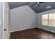 Bright bedroom with high ceilings and wood-look floors is naturally illuminated by a window at 17537 Tuscany Ln, Cornelius, NC 28031