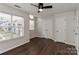 A bedroom featuring wood floors, two windows and a closet with double doors at 17537 Tuscany Ln, Cornelius, NC 28031
