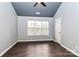 Bedroom with ceiling fan, high ceilings and wood-look floors is naturally illuminated by a window at 17537 Tuscany Ln, Cornelius, NC 28031