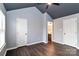 Spacious bedroom leading to bathroom featuring modern gray color palette, high ceilings and wood-look floors at 17537 Tuscany Ln, Cornelius, NC 28031