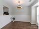 Well lit dining room with tile floors, bead board trim, and window to kitchen at 17537 Tuscany Ln, Cornelius, NC 28031