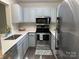 Modern kitchen featuring sleek appliances, light-colored cabinetry, and quartz countertops at 17537 Tuscany Ln, Cornelius, NC 28031