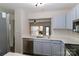 Kitchen features stainless steel appliances, light blue cabinets, and an open layout at 17537 Tuscany Ln, Cornelius, NC 28031