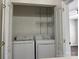 Convenient laundry closet with shelving and modern appliances at 17537 Tuscany Ln, Cornelius, NC 28031
