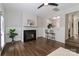 Inviting living room with hardwood floors, fireplace, and breakfast bar through to kitchen at 17537 Tuscany Ln, Cornelius, NC 28031