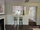 Inviting living room showcasing a breakfast bar pass-through into the kitchen and access to the stairwell at 17537 Tuscany Ln, Cornelius, NC 28031