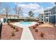 Community pool surrounded by meticulous landscaping, featuring an inviting space for relaxation at 17537 Tuscany Ln, Cornelius, NC 28031