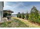 A well-maintained backyard featuring a patio, lush green grass, and mature trees, perfect for outdoor activities at 181 Atwater Landing Dr, Mooresville, NC 28117