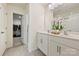Bathroom featuring double sinks, white cabinetry, large mirror, and access to walk-in closet at 181 Atwater Landing Dr, Mooresville, NC 28117
