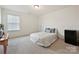 Cozy bedroom with a comfortable bed, side table, and mini fridge at 181 Atwater Landing Dr, Mooresville, NC 28117