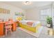 Vibrant bedroom featuring a yellow platform bed, colorful decor, and study desk at 181 Atwater Landing Dr, Mooresville, NC 28117