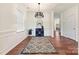 Open dining room with modern chandelier, neutral paint, hardwood floors and abundant natural light at 181 Atwater Landing Dr, Mooresville, NC 28117